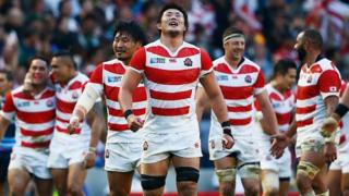 Japan players celebrate victory over South Africa in the Rugby World Cup