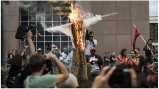 EFFDIGY OF PRESIDENT DONALD TRUMP BURNED AS A PROTEST AGAINST HATE CRIMES