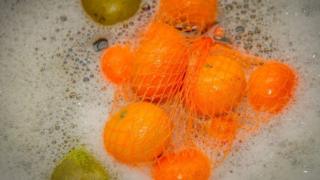 Oranges in washing up bowl