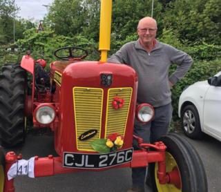 Kev Chambers standing next to a vintage tractor