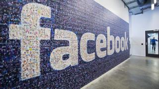 Facebook logo on wall