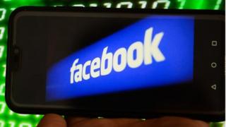 Facebook logo inside phone