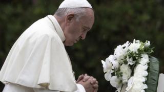 Pope Francis prays after laying a wreath to the Hypocenter Cenotaph at the Atomic Bomb Hypocenter Park