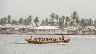 People crowd a small boat in Lagos