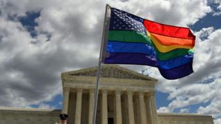 A supporter of gay marriage waves his rainbow flag in front of the U.S. Supreme Court in Washington DC.