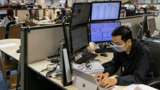 A stock broker follows the Hang Seng Index in Hong Kong.