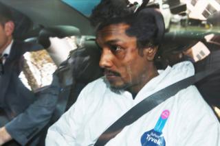 A man who was arrested for trying to enter the cockpit of a Malaysia Airlines flight is driven into the Melbourne Magistrates' Court