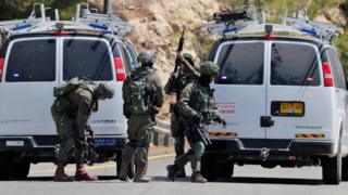 Israeli troops gather at the site of a bomb explosion that killed an Israeli teenager, near the settlement of Dolev in the occupied West Bank (23 August 2019)