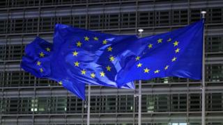 European Union flags in front of the Berlaymont Building in Brussels