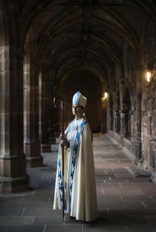 Portrait of a bishop in a church corridor