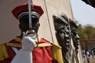 A soldier stands under the bronze statue of Burkina Faso's former President Thomas Sankara on 2 March 2019.