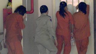 Women detainees escorted by Cambodian police arrive at the Phnom Penh municipal court for sentencing over commercial surrogacy, 3 August 2017