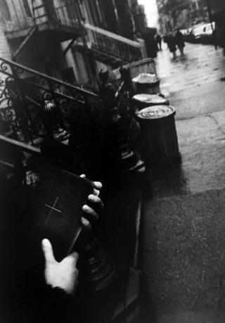Man holding a bible on a New York street