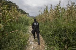 The policewoman walks through some fields