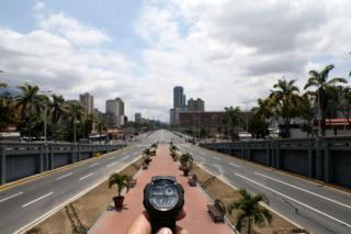 A watch showing the time at noon in front of Bolivar Avenue in Caracas, Venezuela