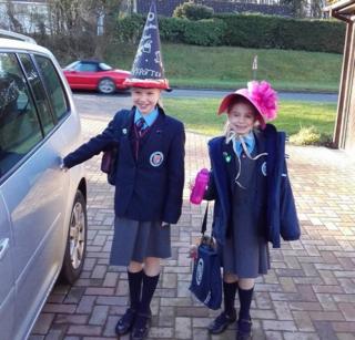 Caitlin and Emily from Saffron Walden in England have made hats representing their favourite books and wore them to school for a hat parade. Caitlin's hat is Harry Potter and Emily's hat is Rose by Holly Webb