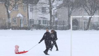 A child on a sledge in the snow