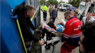 Medical workers transport on a stretcher a wounded woman arriving by a train carrying people evacuated for treatment from Donetsk and Dnipropetrovsk regions, 21 May 2022