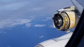 A photo shows the view form a plane in mid-air, with a severely damaged engine clearly visible, with parts missing and substantial metal damage