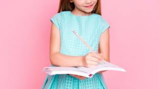 Stock image of a child writing