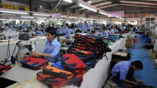 Employees of Ladoda company's leather factory, work on a production line in Van Lam district, northern province of Hung Yen on October 17, 2008