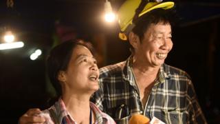 Family members celebrate while camping out near Than Luang cave following news all members of children"s football team