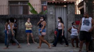 People wearing masks in the street in Sao Paulo, Brazil.