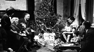 Family around Christmas tree in 1947