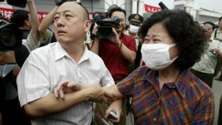 A woman leaves Xiaotangshan after being treated for SARS