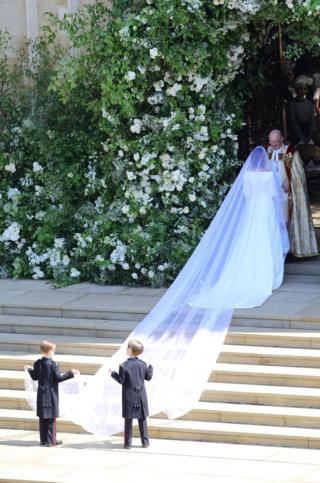 David Conner (R), the Dean of Windsor, welcoming Meghan Markle arriving at her royal wedding ceremony with Britain's Prince Harry at St George's Chapel in Windsor Castle