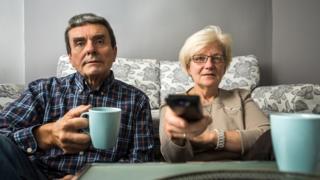 Couple watching TV at their home
