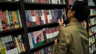 A man looks at political books on sale in Hong Kong