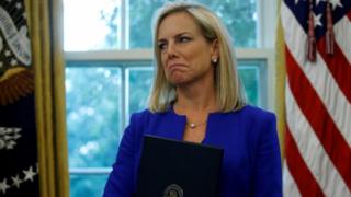 Former US Homeland Security Secretary Kirstjen Nielsen holding an executive order on immigration policy