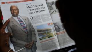 A person reads a newspaper article the death of former Kenya's President Daniel arap Moi, in Nairobi on 4 February 2020
