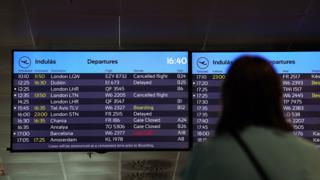 A passenger looks at a departure board at Ferenc Liszt International Airport in Budapest, Hungary