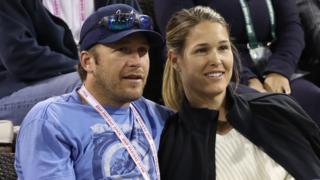 Bode Miller and his wife Morgan watch a tennis match