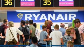 People queuing up to check in for a Ryanair flight