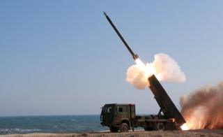 A rocket is launched during a demonstration of a new large-calibre multiple rocket launching system at an unknown location in an undated photo released by North Korea's Korean Central News Agency (KCNA) on 22 March 2016.