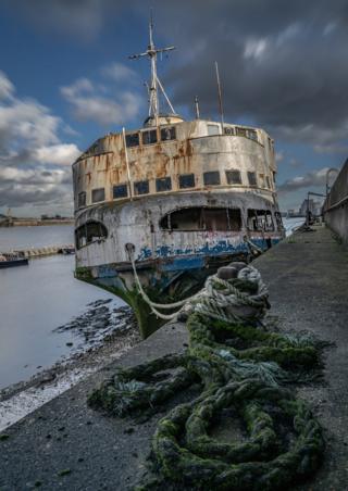 Derelict ship at a harbour