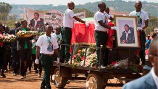 The bearers guard the coffin of Jonas Savimbi, former leader of the UNITA movement, during the reburial of the remains on June 1, 2019 in his native village of Lopitanga, near the town of Andulo, in Angola's Bie province.