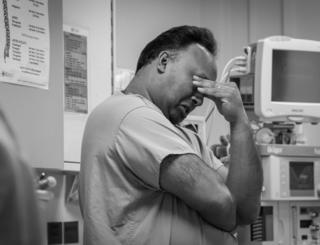 A medic rubs his eyes on the intensive therapy unit