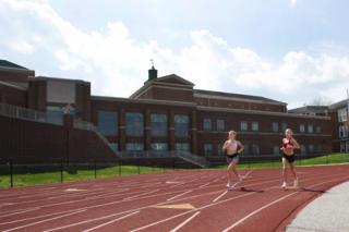 Maddie's sister Sabina runs on an empty track with her friend