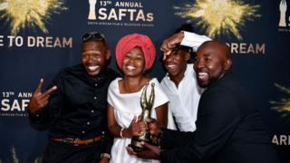 Phiwe Mkhanzi and Sthembiso Mathenjwa, the directors of IsiBaya, pose with their award statuette for Best Achievement in Directing.