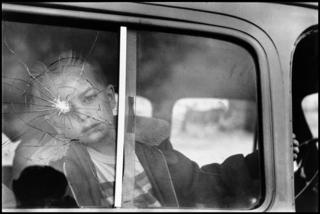 Boy in a car with a broken window