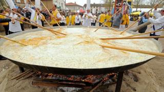 Giant omelette being cooked.