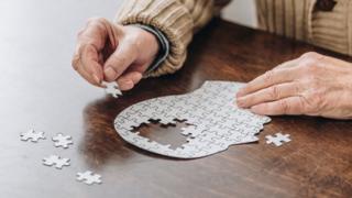 Man working on a brain jigsaw