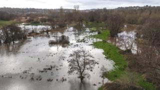 The River Wey bursts its banks near Godalming, Surrey, on Wednesday.