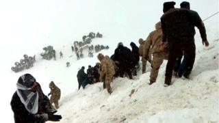 Turkish soldiers and locals try to rescue people trapped under snow following an avalanche in Bahcesaray in Van province, Turkey, 5 February 2020
