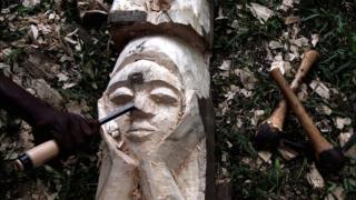 Kaba Abdoulaye, a sculptor from Guinea, works during the Francophone Games in Abidjan, Ivory Coast July 25, 2017.
