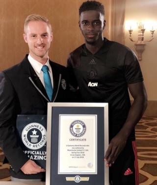 Picture of Axel Tuanzebe being awarded with his certificate from Guinness World Record